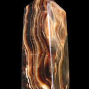 Chocolate Calcite obelisk 84*33*28mm 175g in sunlight - Rocks and Things Store