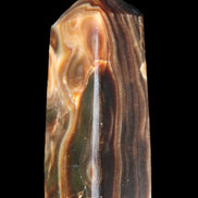 Chocolate Calcite obelisk 84*33*28mm 175g in sunlight - Rocks and Things Store