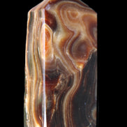 Chocolate Calcite obelisk 84*33*28mm 175g in sunlight - Rocks and Things Store