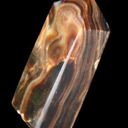 Chocolate Calcite obelisk 84*33*28mm 175g in sunlight - Rocks and Things Store