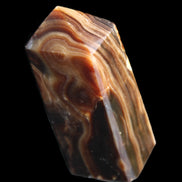 Chocolate Calcite obelisk 84*33*28mm 175g in sunlight - Rocks and Things Store