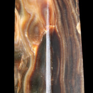 Chocolate Calcite obelisk 84*33*28mm 175g in sunlight - Rocks and Things Store