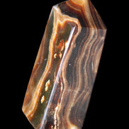 Chocolate Calcite obelisk 84*33*28mm 175g in sunlight - Rocks and Things Store