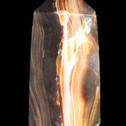 Chocolate Calcite obelisk 62*25*21mm 73g in sunlight - Rocks and Things Store