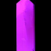 Mangano Calcite UV-reactive obelisk 92mm 157g in sunlight - Rocks and Things Store