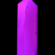 Mangano Calcite UV-reactive obelisk 92mm 157g in sunlight - Rocks and Things Store