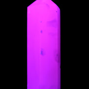 Mangano Calcite UV-reactive obelisk 92mm 157g in sunlight - Rocks and Things Store