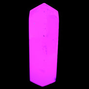 Mangano Calcite UV-reactive obelisk 92mm 157g in sunlight - Rocks and Things Store