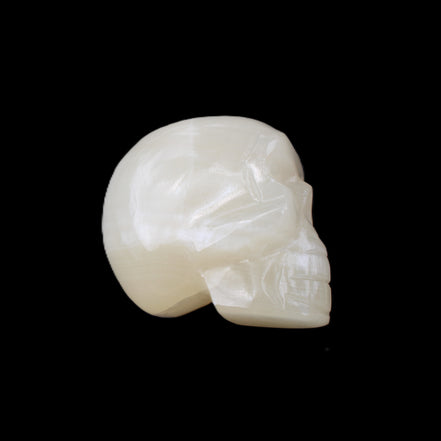 Honey Calcite skull hand-carved 53*46*32mm 143g in sunlight - Rocks and Things Store