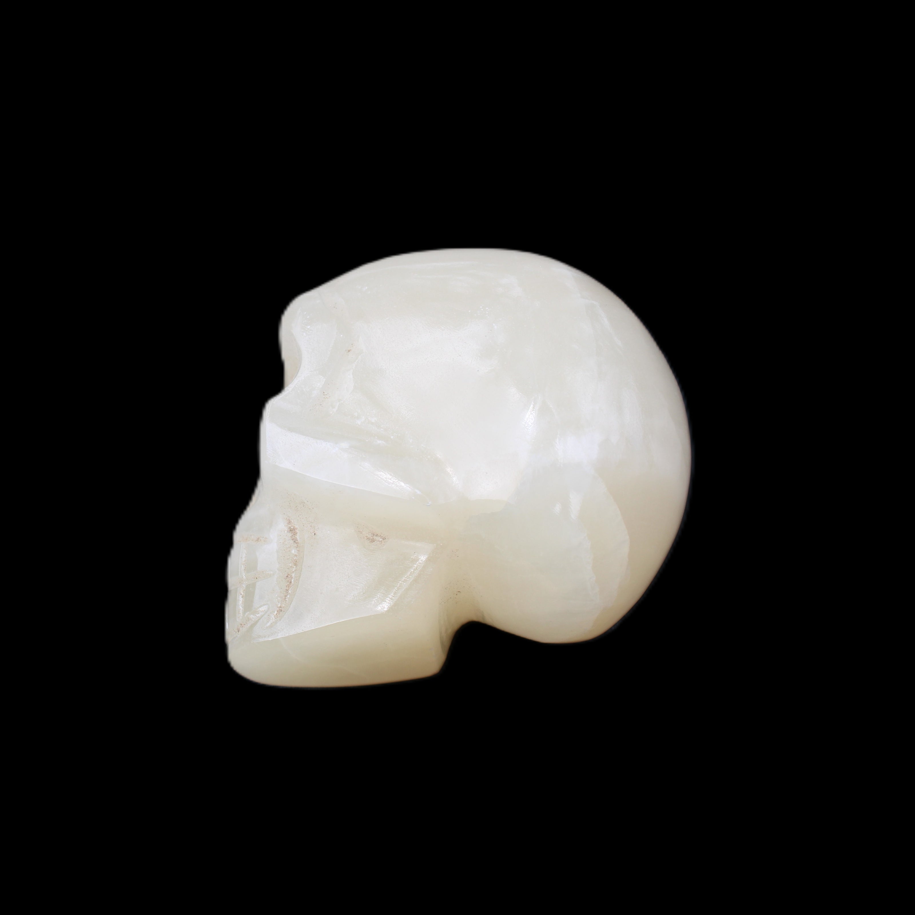 Honey Calcite skull hand-carved 53*46*32mm 143g in sunlight - Rocks and Things Store