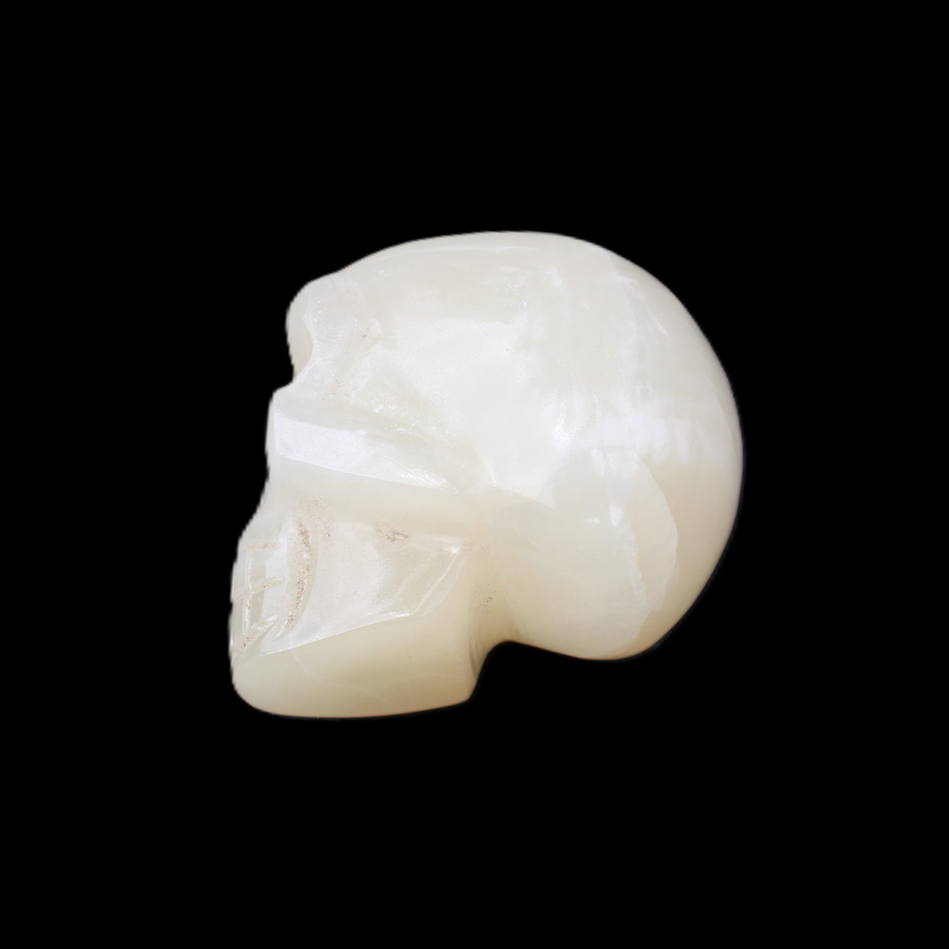 Honey Calcite skull hand-carved 53*46*32mm 143g in sunlight - Rocks and Things Store