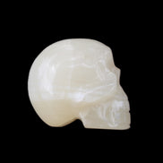 Honey Calcite skull hand-carved 53*46*32mm 143g in sunlight - Rocks and Things Store