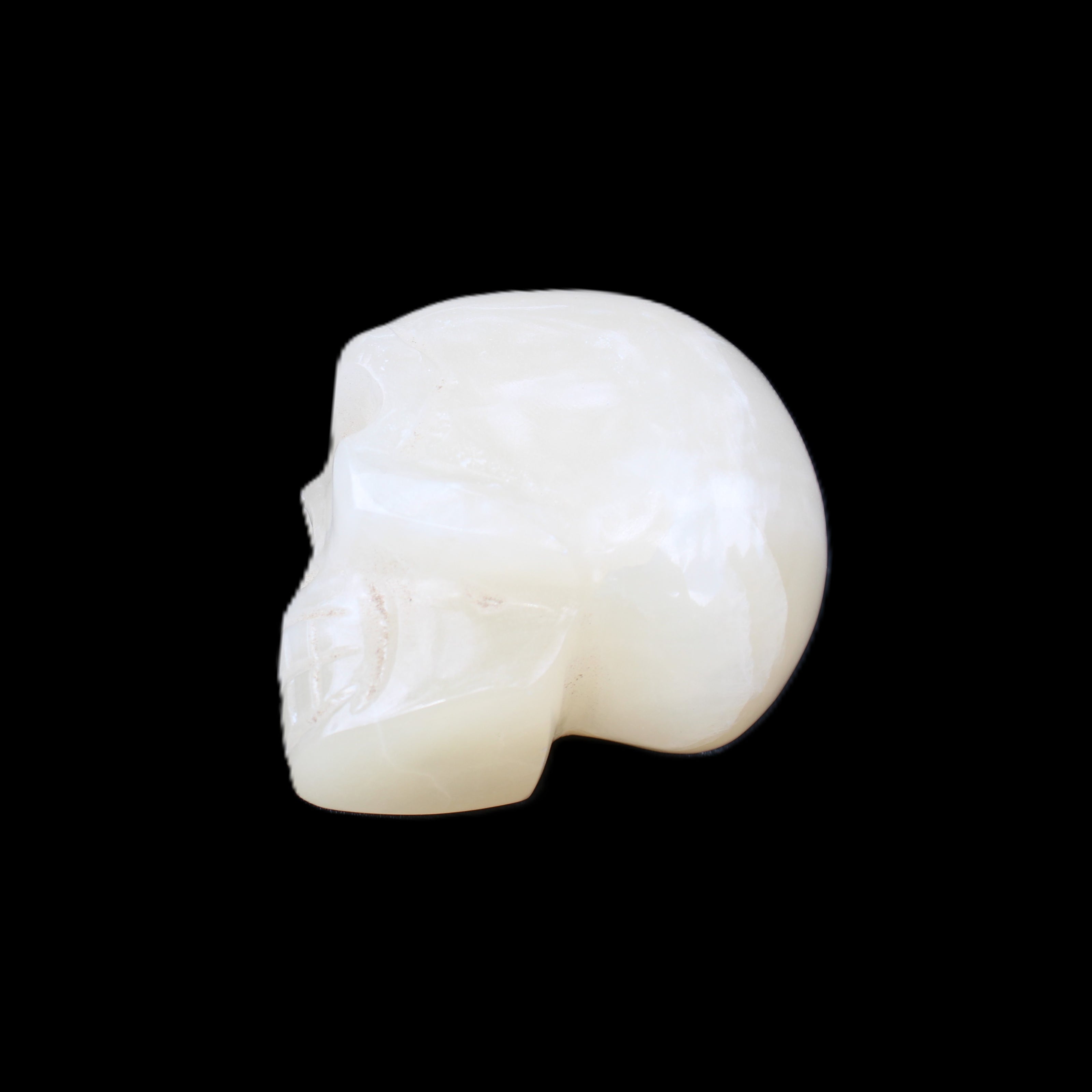 Honey Calcite skull hand-carved 53*46*32mm 143g in sunlight - Rocks and Things Store