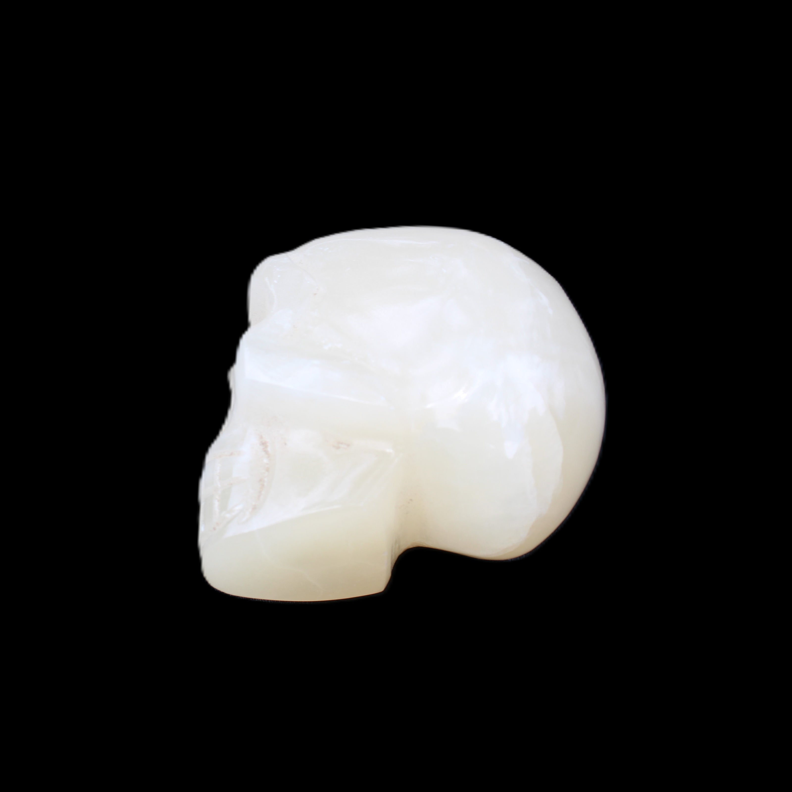 Honey Calcite skull hand-carved 53*46*32mm 143g in sunlight - Rocks and Things Store