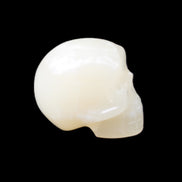 Honey Calcite skull hand-carved 53*46*32mm 143g in sunlight - Rocks and Things Store