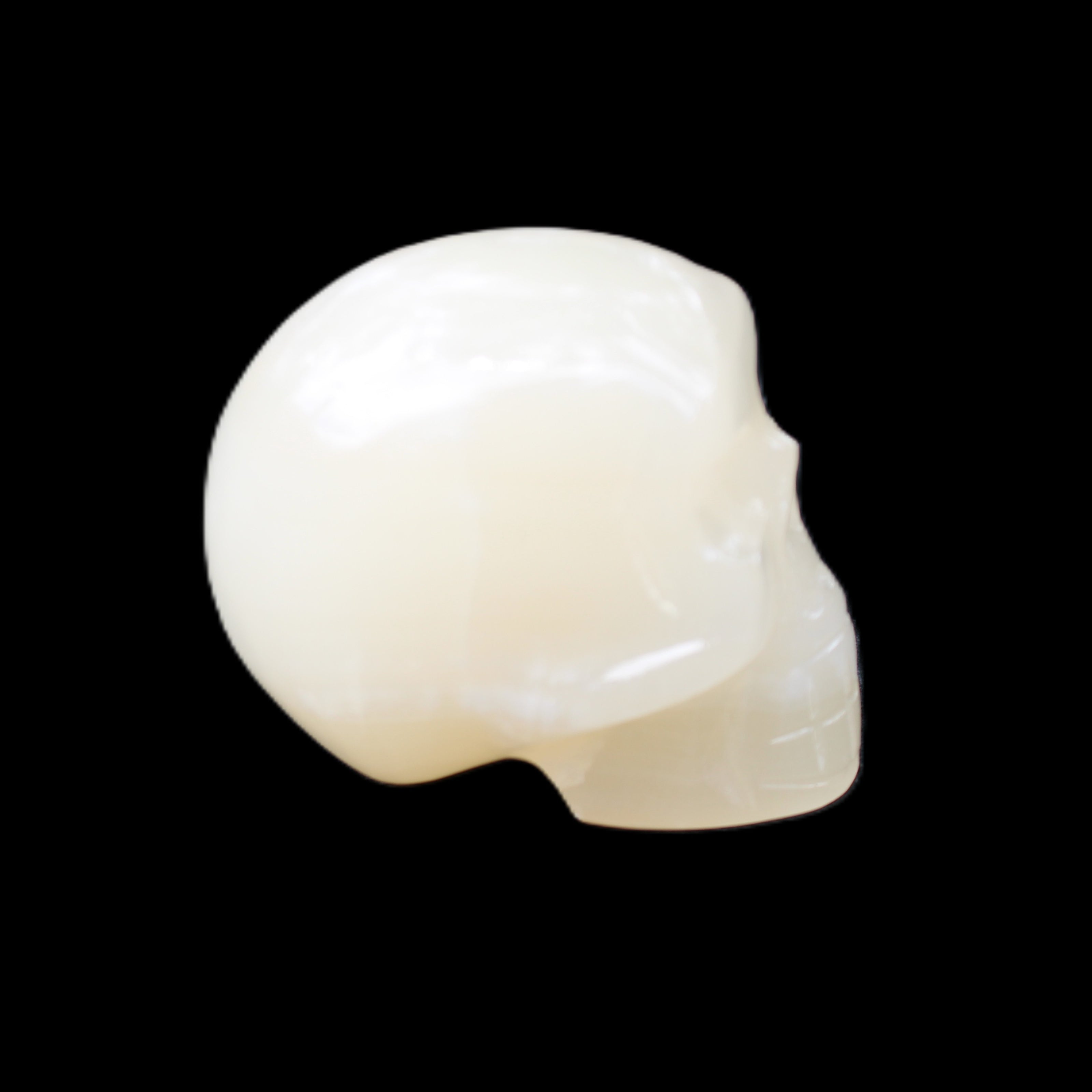 Honey Calcite skull hand-carved 53*46*32mm 143g in sunlight - Rocks and Things Store