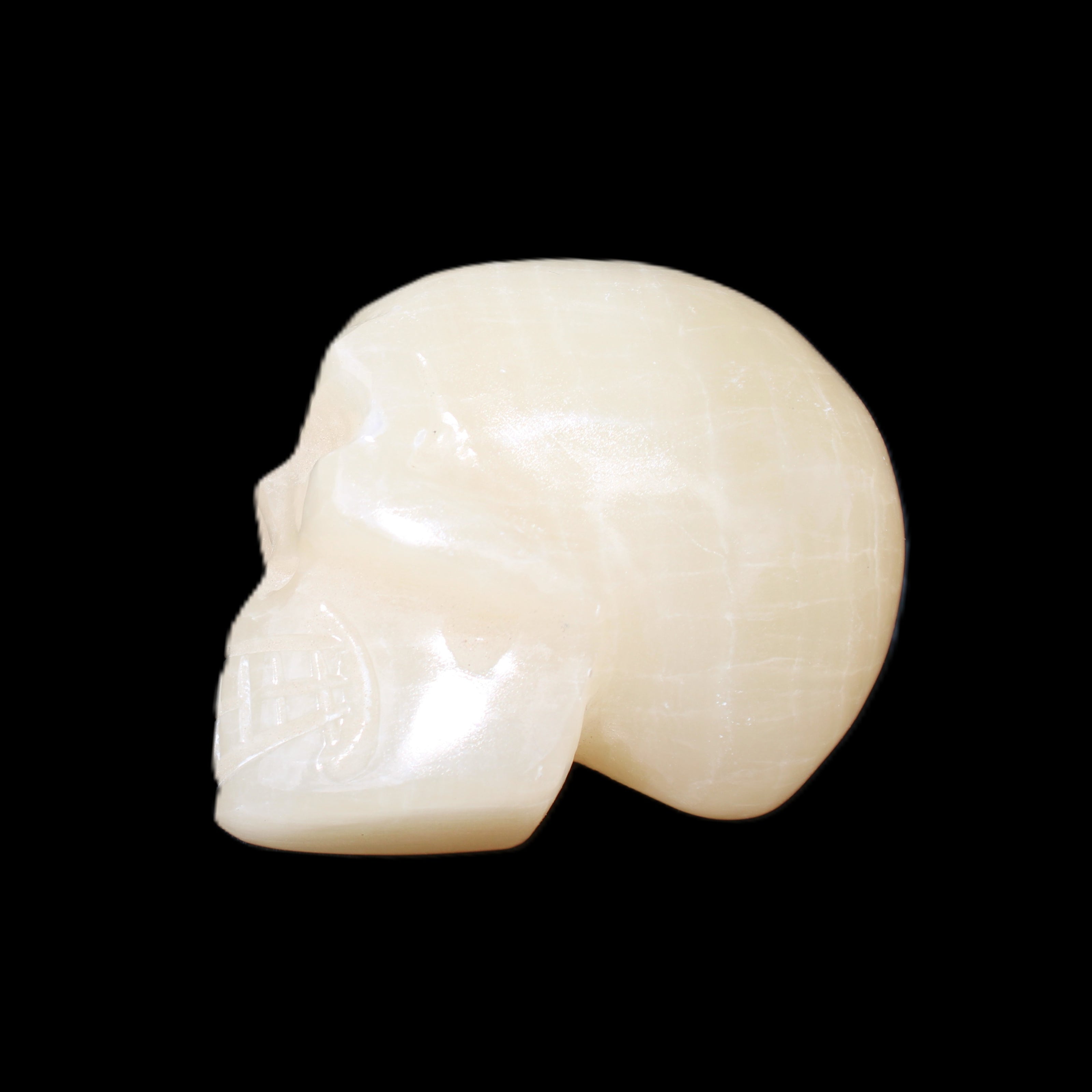 Honey Calcite skull hand-carved 60*50*39mm 192g in sunlight - Rocks and Things Store