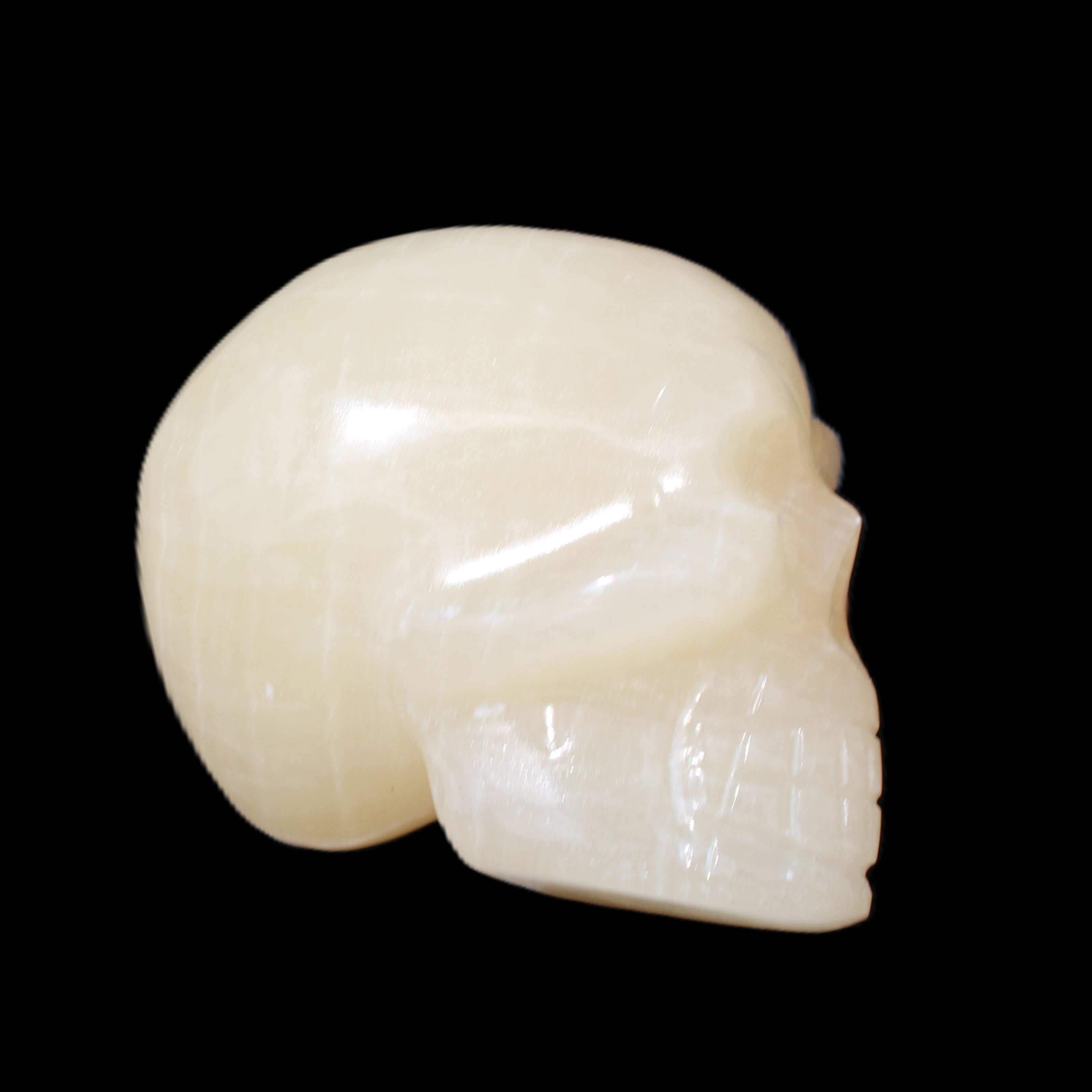 Honey Calcite skull hand-carved 60*50*39mm 192g in sunlight - Rocks and Things Store