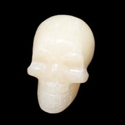 Honey Calcite skull hand-carved 60*50*39mm 192g in sunlight - Rocks and Things Store