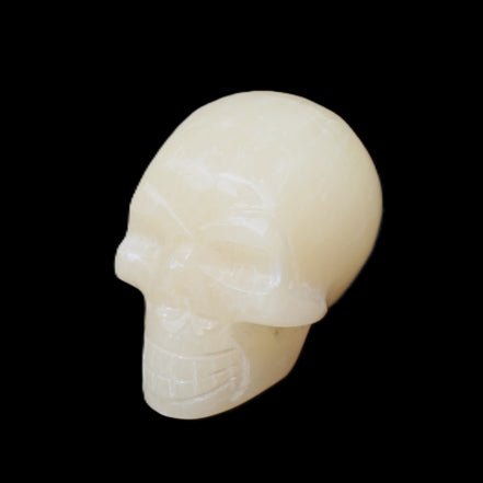 Honey Calcite skull hand-carved 60*50*39mm 192g in sunlight - Rocks and Things Store