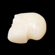 Honey Calcite skull hand-carved 60*50*39mm 192g in sunlight - Rocks and Things Store