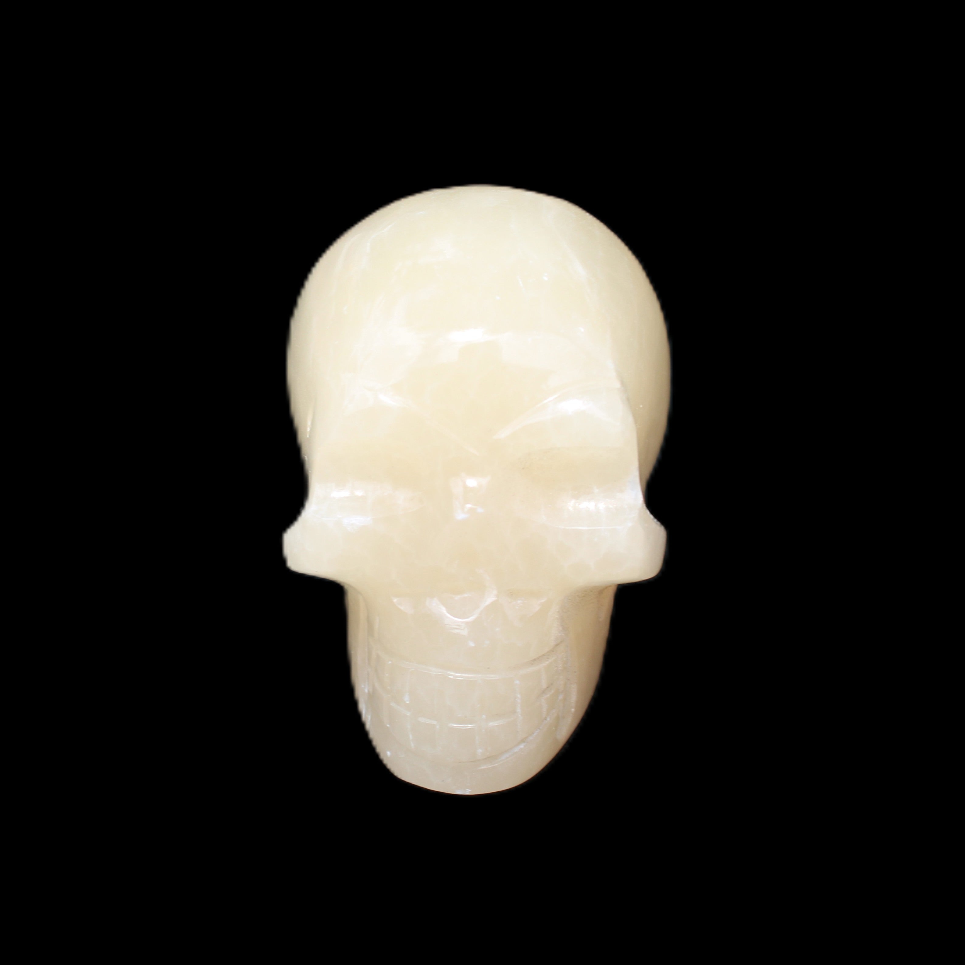Honey Calcite skull hand-carved 60*50*39mm 192g in sunlight - Rocks and Things Store