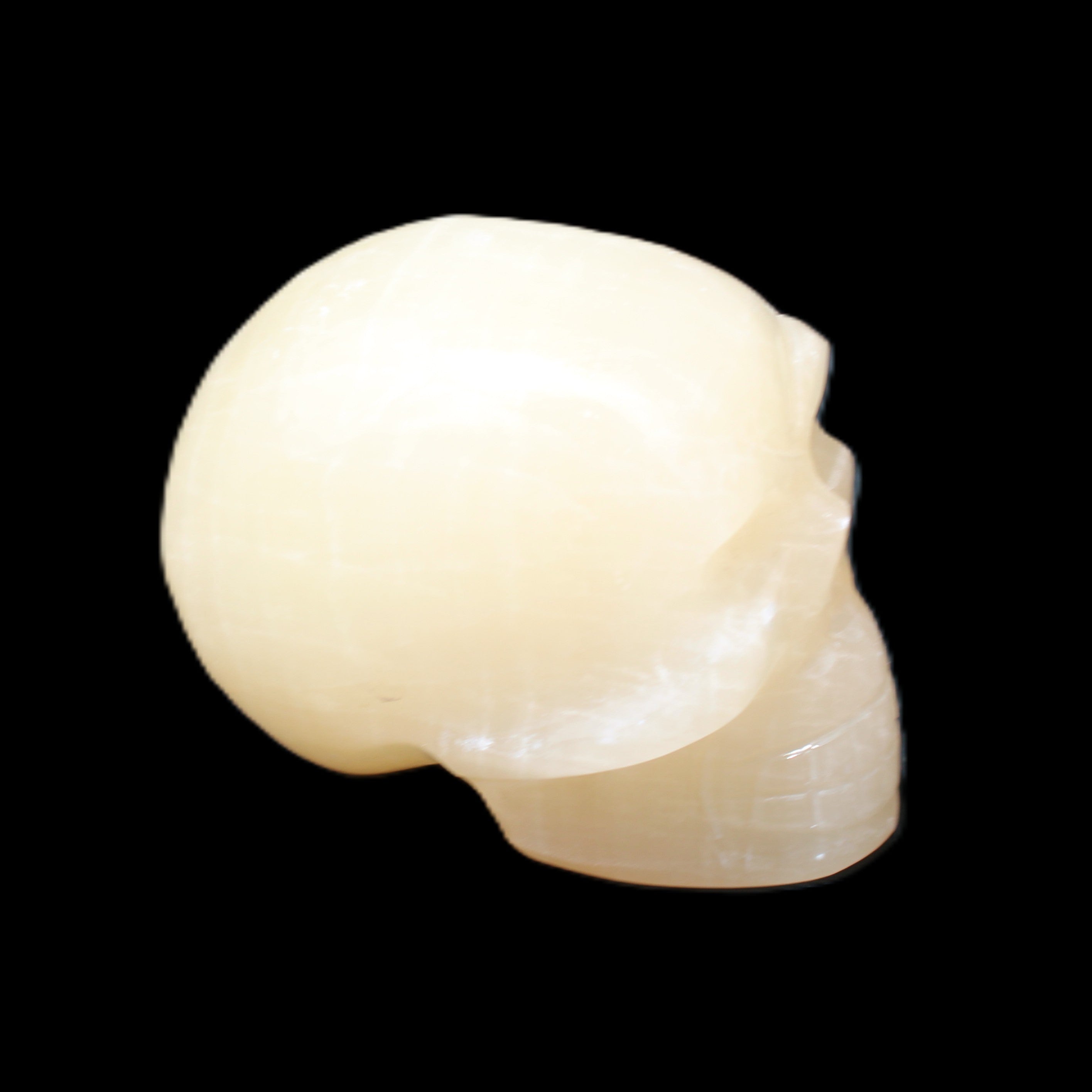Honey Calcite skull hand-carved 60*50*39mm 192g in sunlight - Rocks and Things Store
