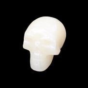 Honey Calcite skull hand-carved 58*48*40mm 175g in sunlight - Rocks and Things Store
