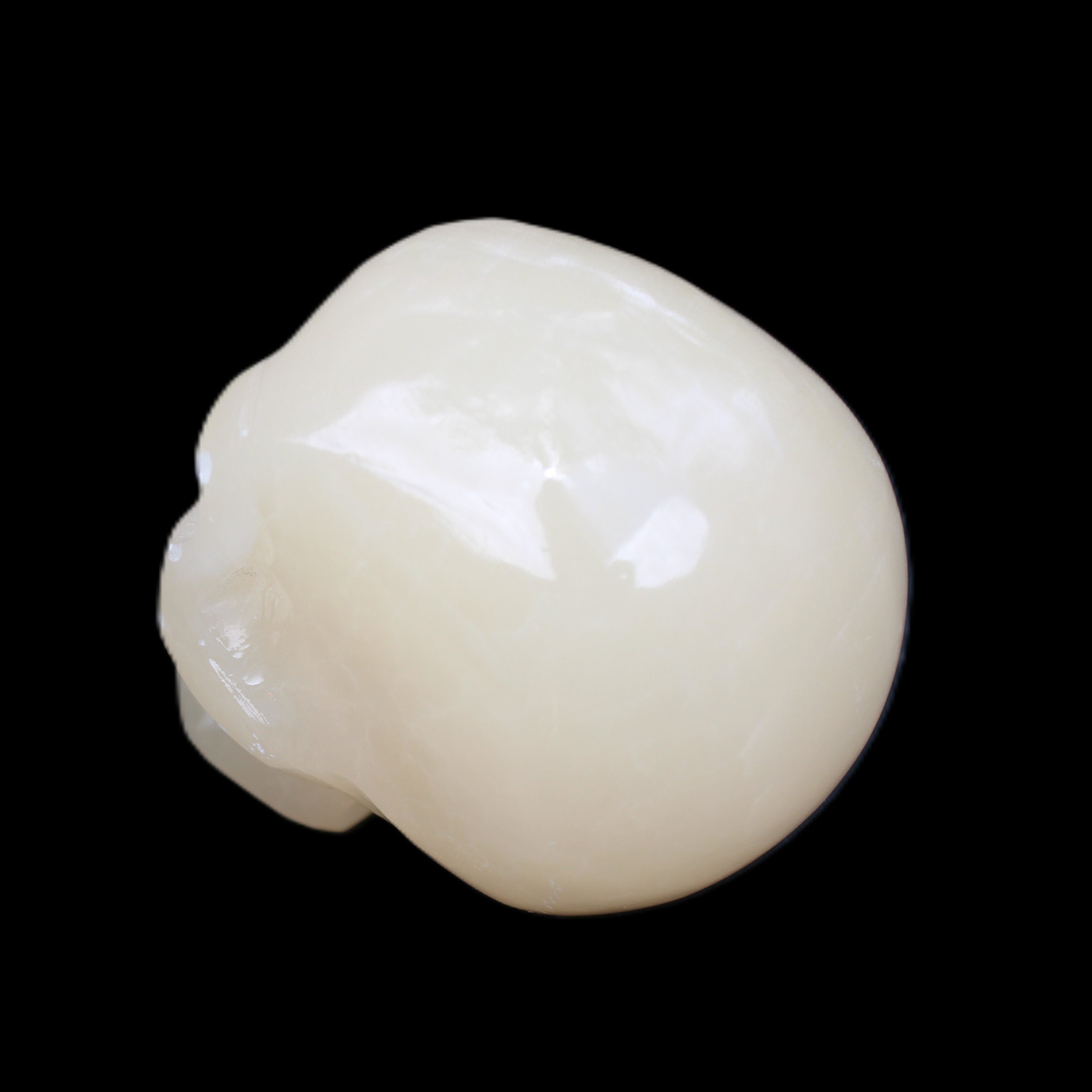 Honey Calcite skull hand-carved 58*48*40mm 175g in sunlight - Rocks and Things Store