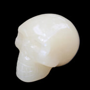 Honey Calcite skull hand-carved 58*48*40mm 175g in sunlight - Rocks and Things Store