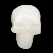 Honey Calcite skull hand-carved 58*48*40mm 175g in sunlight - Rocks and Things Store