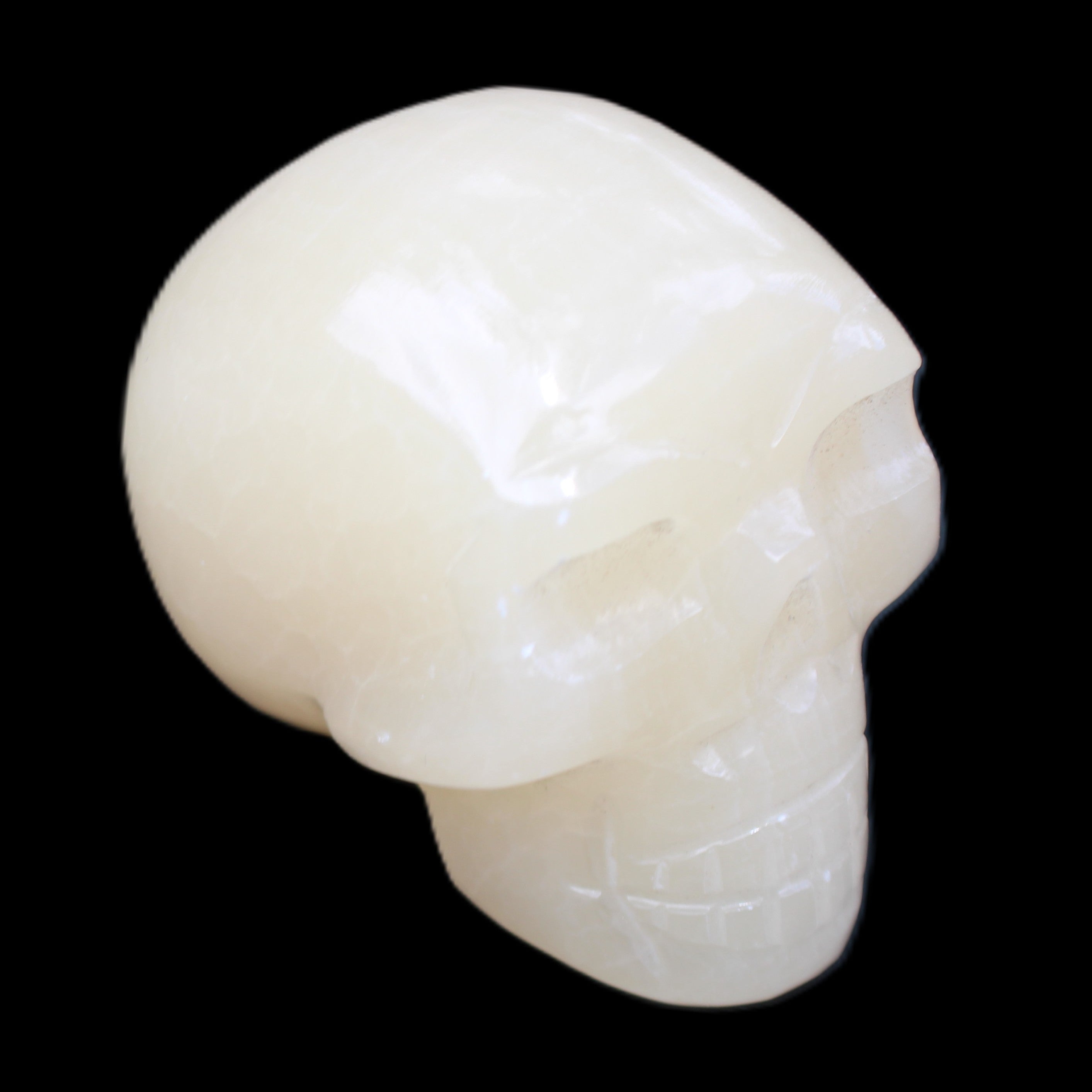 Honey Calcite skull hand-carved 58*48*40mm 175g in sunlight - Rocks and Things Store