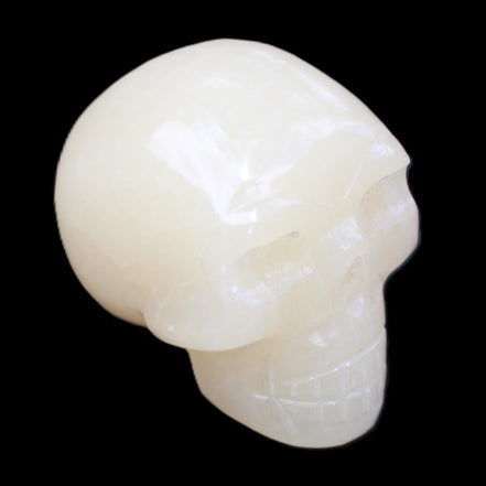 Honey Calcite skull hand-carved 58*48*40mm 175g in sunlight - Rocks and Things Store