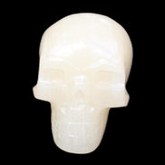 Honey Calcite skull hand-carved 58*48*40mm 175g in sunlight - Rocks and Things Store