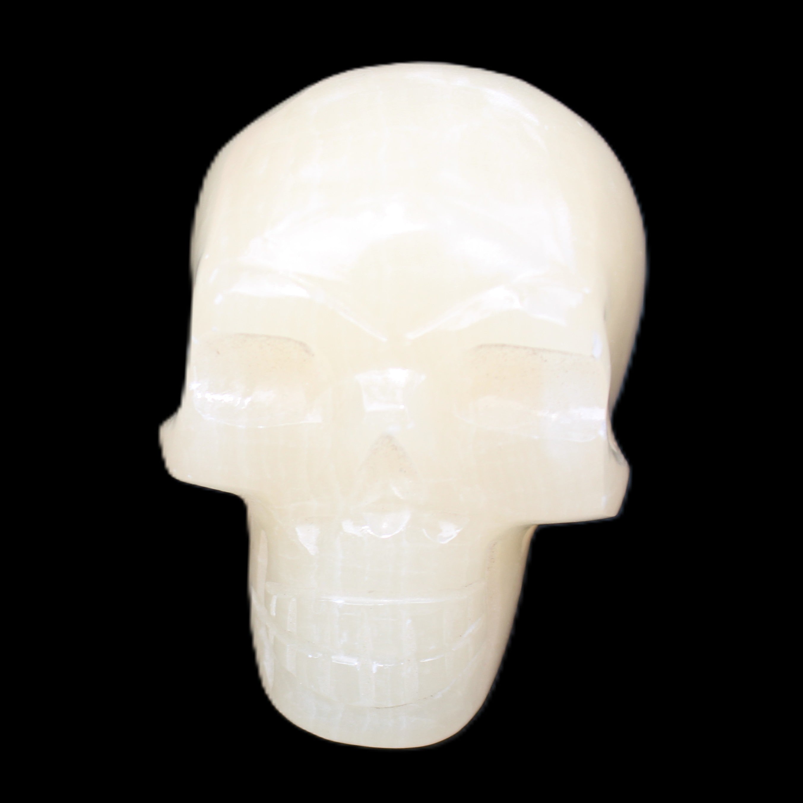 Honey Calcite skull hand-carved 58*48*40mm 175g in sunlight - Rocks and Things Store