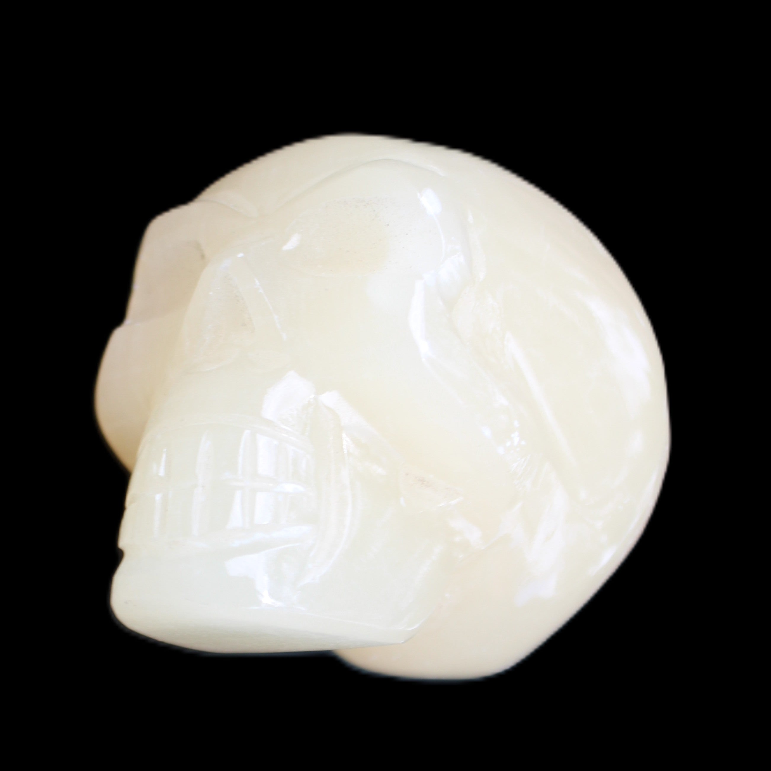 Honey Calcite skull hand-carved 58*48*40mm 175g in sunlight - Rocks and Things Store