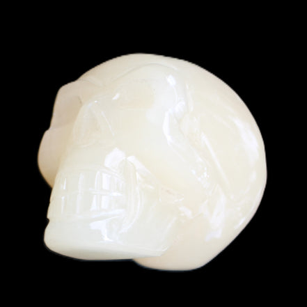 Honey Calcite skull hand-carved 58*48*40mm 175g in sunlight - Rocks and Things Store
