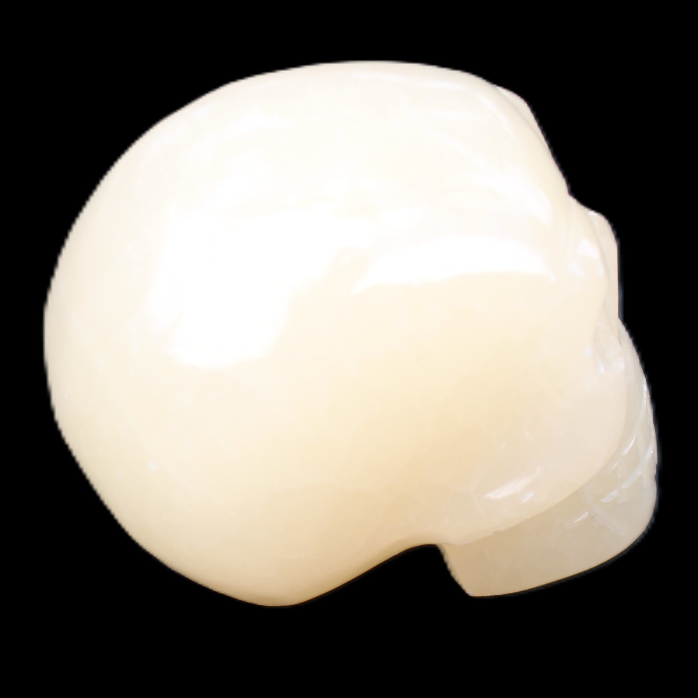 Honey Calcite skull hand-carved 58*48*40mm 175g in sunlight - Rocks and Things Store