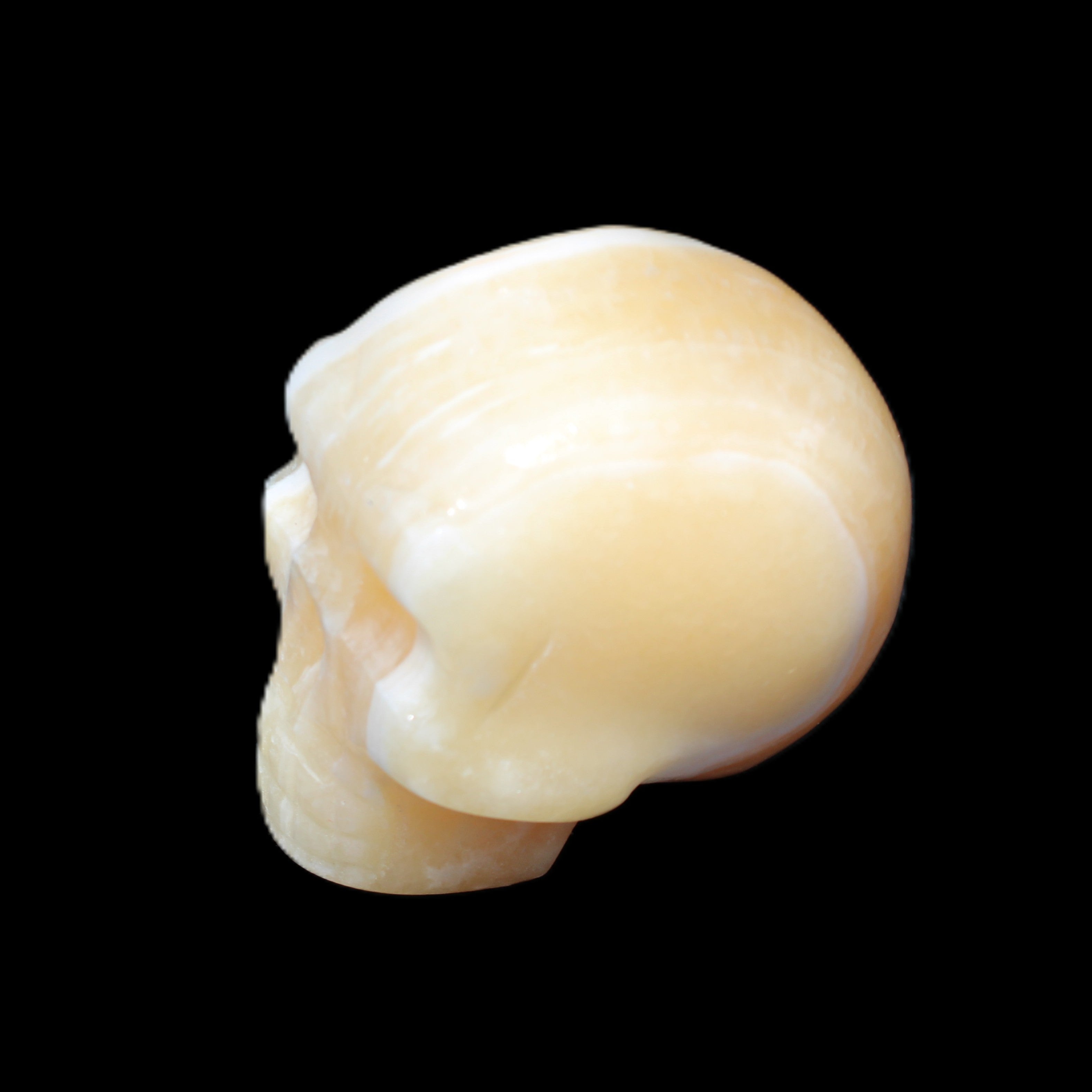 Yellow Calcite skull hand-carved 49*43*34mm 131g in sunlight - Rocks and Things Store