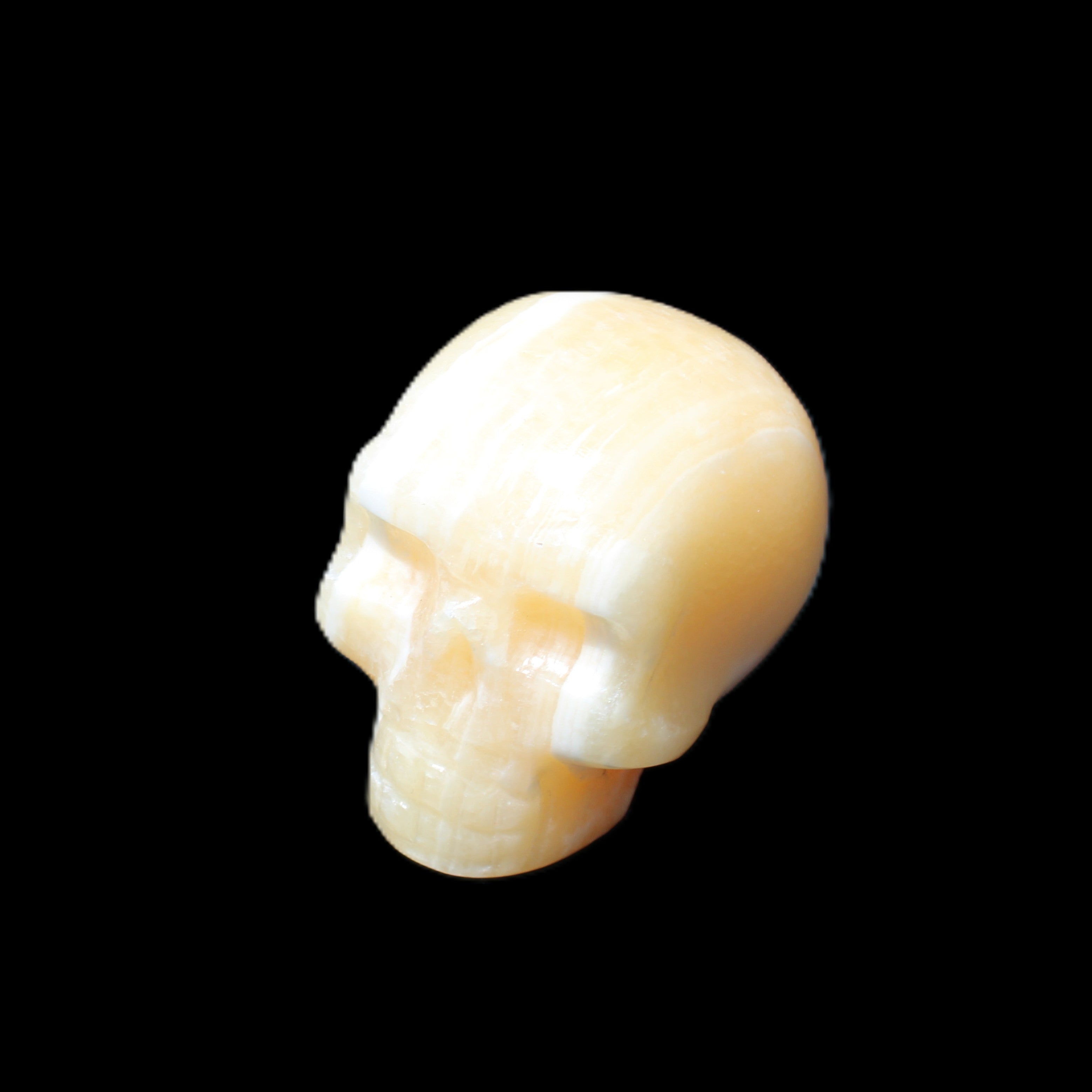 Yellow Calcite skull hand-carved 49*43*34mm 131g in sunlight - Rocks and Things Store