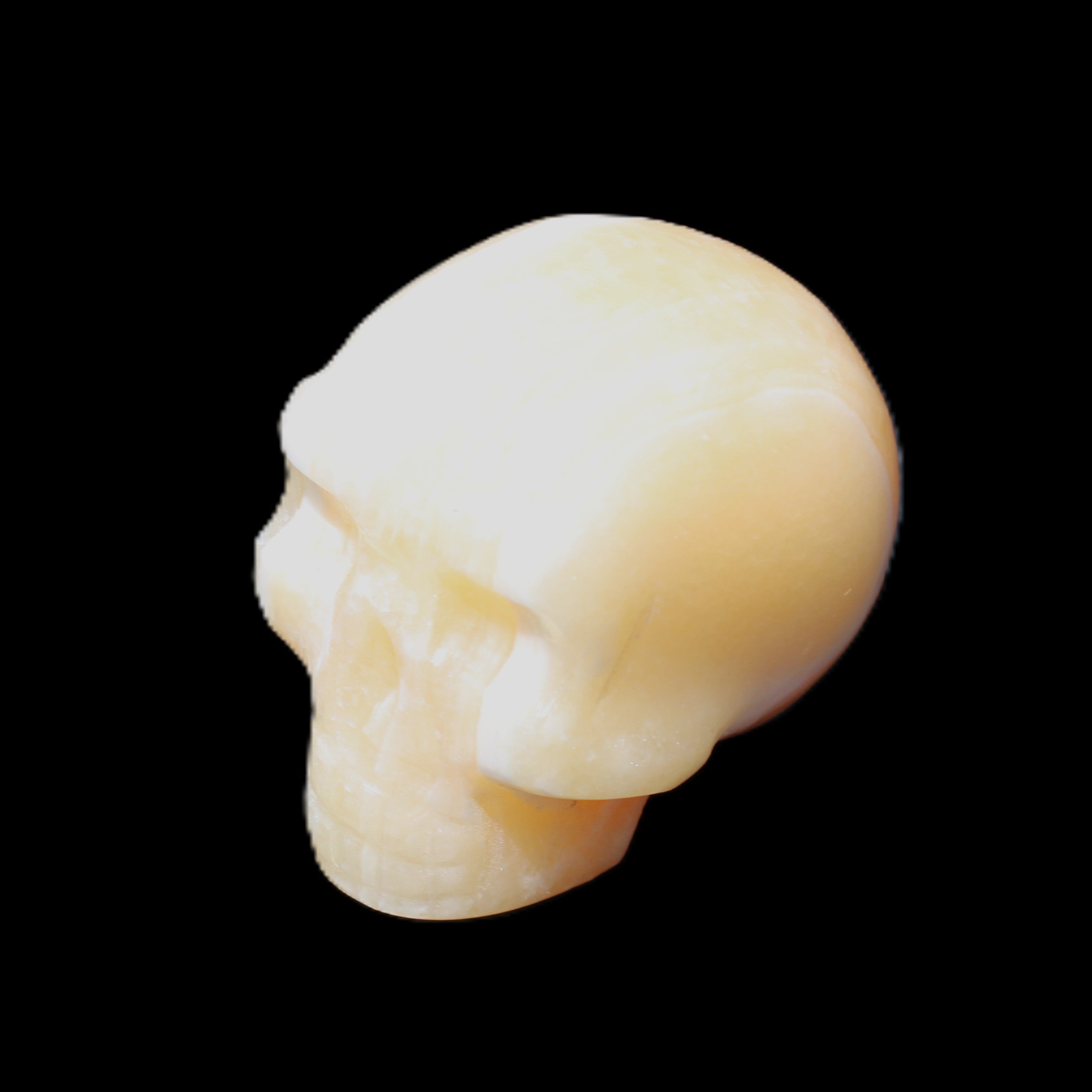 Yellow Calcite skull hand-carved 49*43*34mm 131g in sunlight - Rocks and Things Store