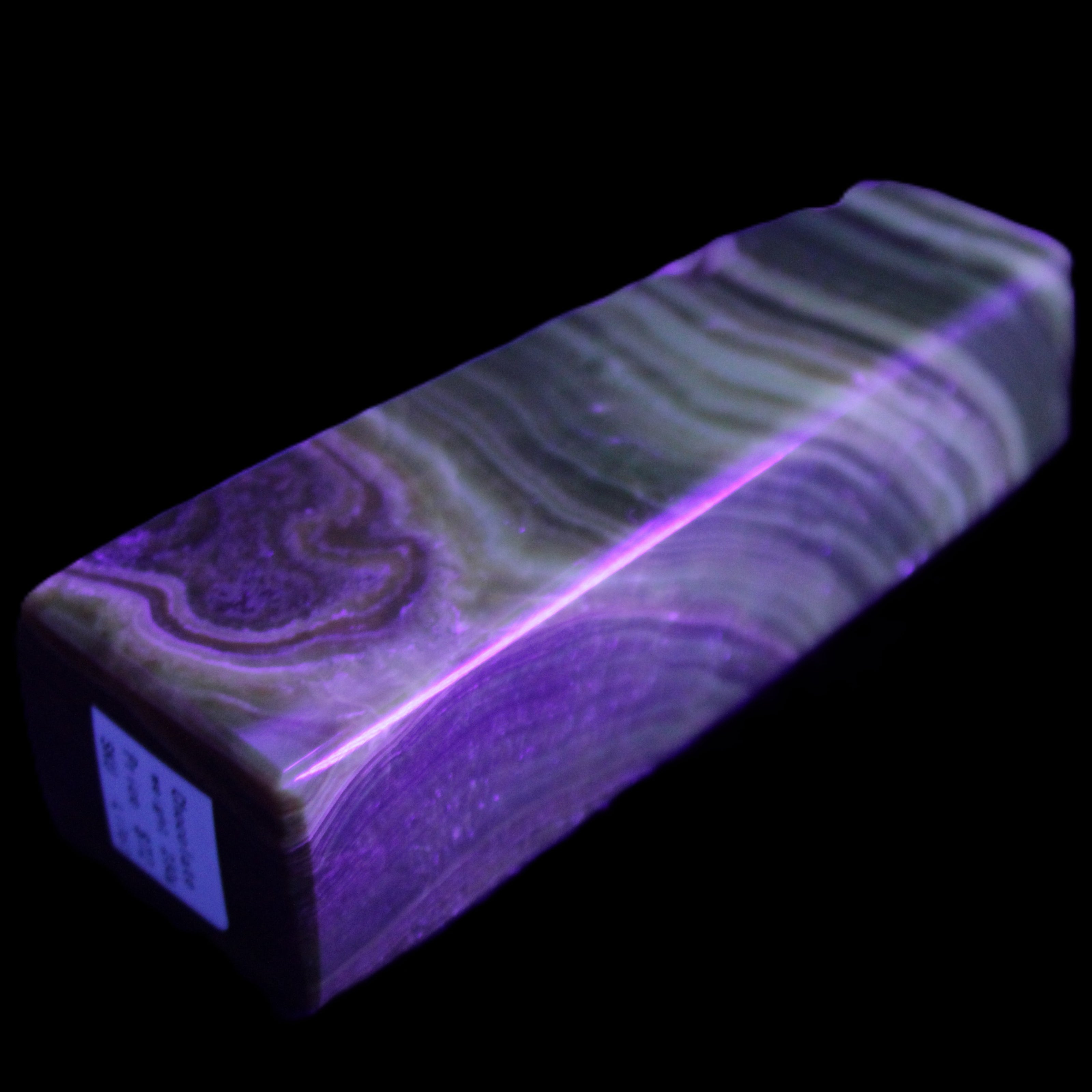 Chocolate Calcite obelisk 112*37mm 230g in UV light - Rocks and Things Store