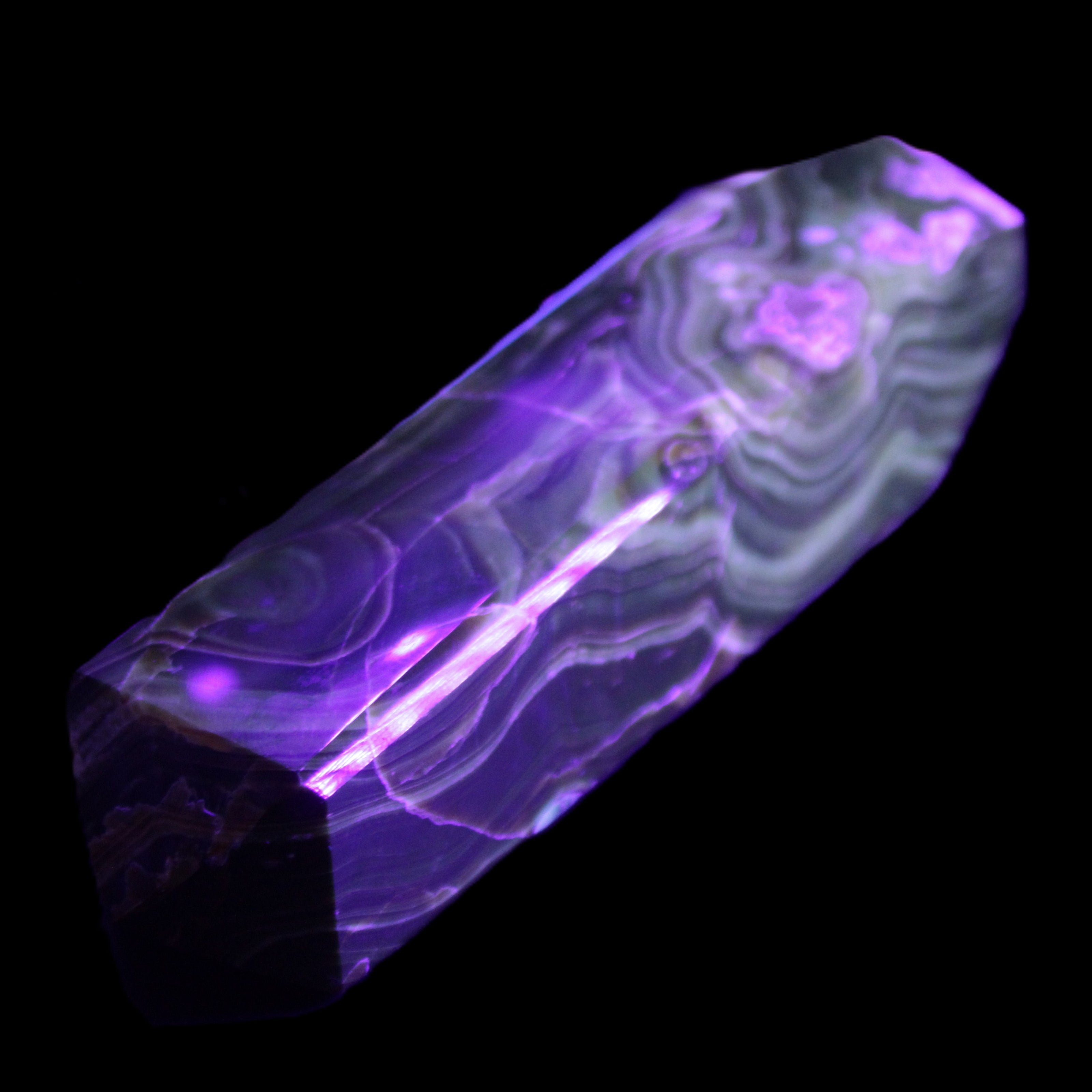 Tall Chocolate Calcite obelisk 154*32mm 439g in UV light - Rocks and Things Store