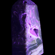 Chocolate Calcite obelisk with caves 95*40mm 217g in UV light - Rocks and Things Store