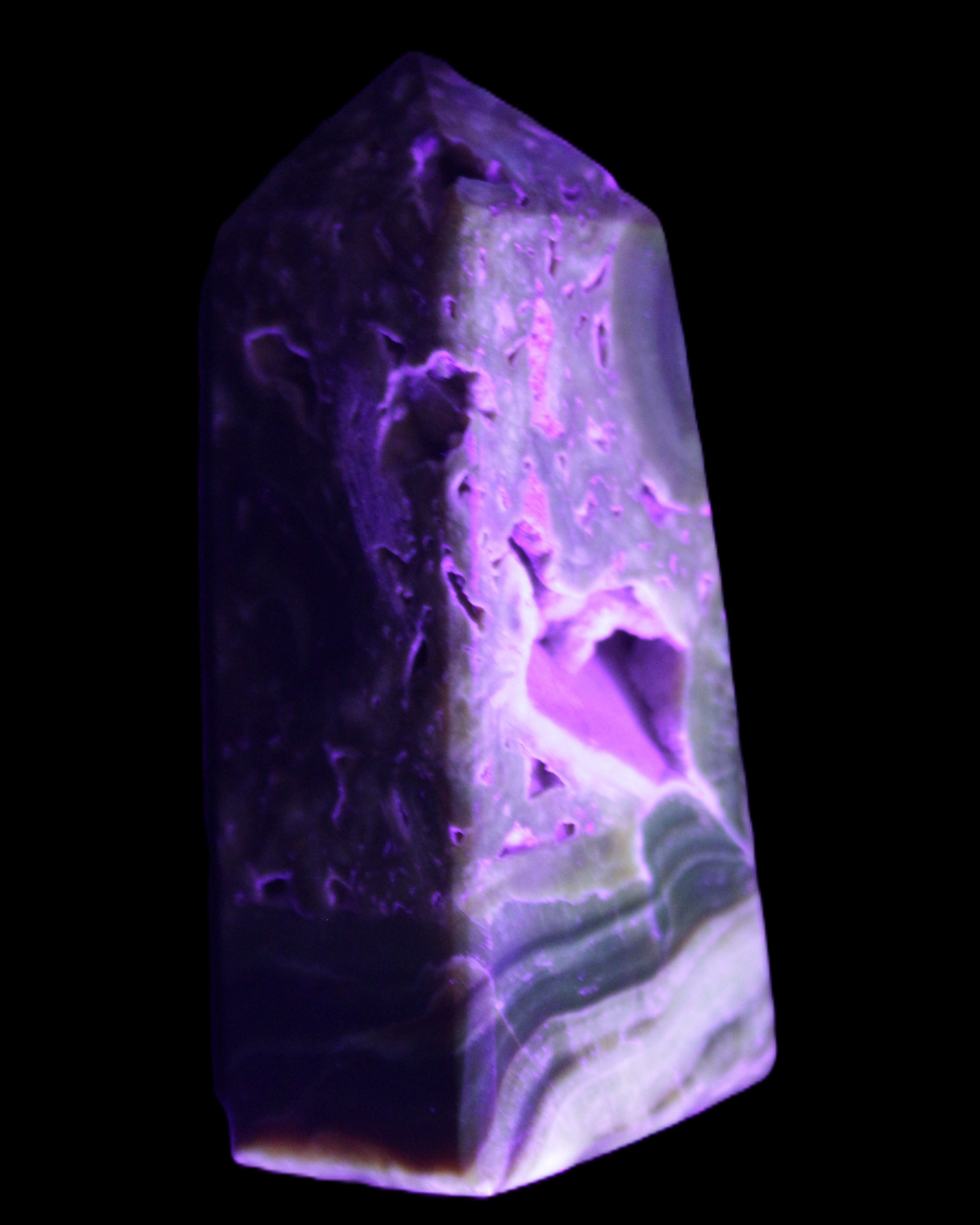 Chocolate Calcite obelisk with caves 95*40mm 217g in UV light - Rocks and Things Store