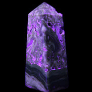 Chocolate Calcite obelisk with caves 95*40mm 217g in UV light - Rocks and Things Store