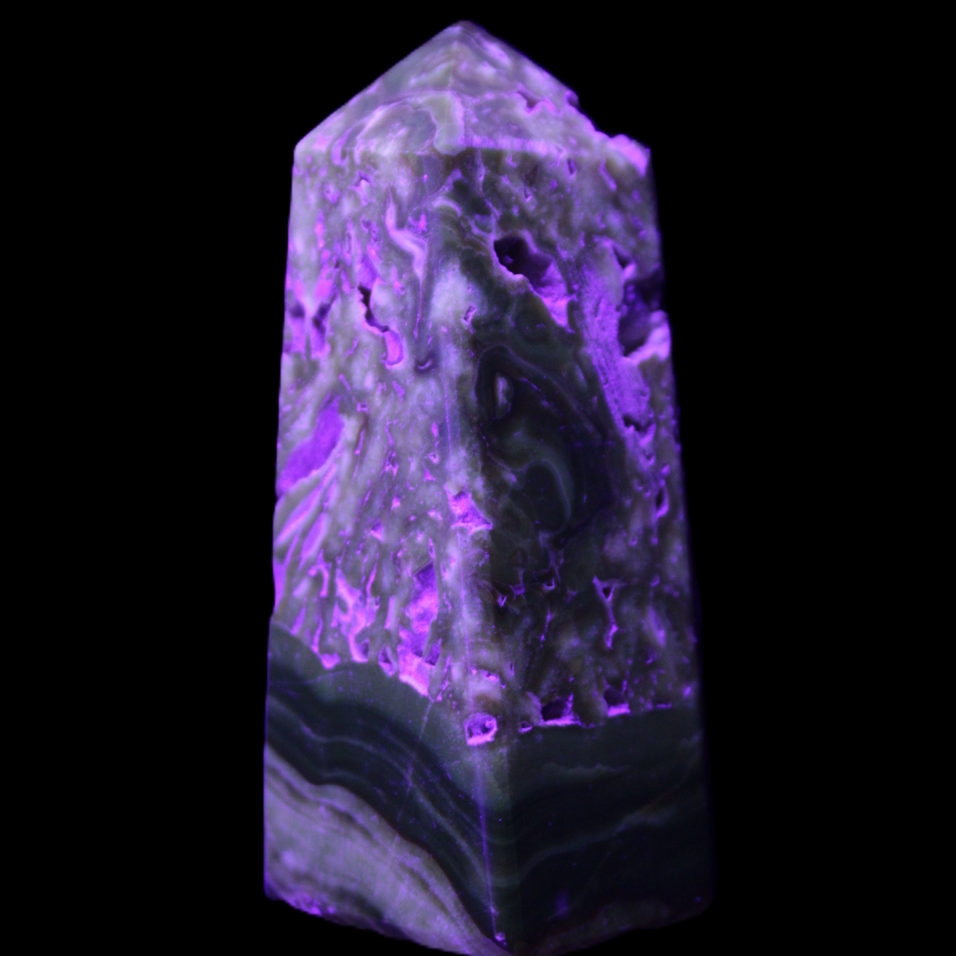 Chocolate Calcite obelisk with caves 95*40mm 217g in UV light - Rocks and Things Store