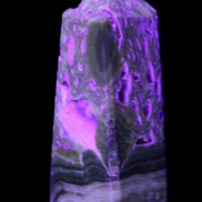Chocolate Calcite obelisk with caves 95*40mm 217g in UV light - Rocks and Things Store
