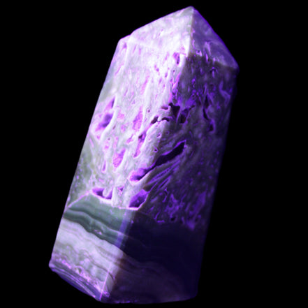 Chocolate Calcite obelisk with caves 95*40mm 217g in UV light - Rocks and Things Store