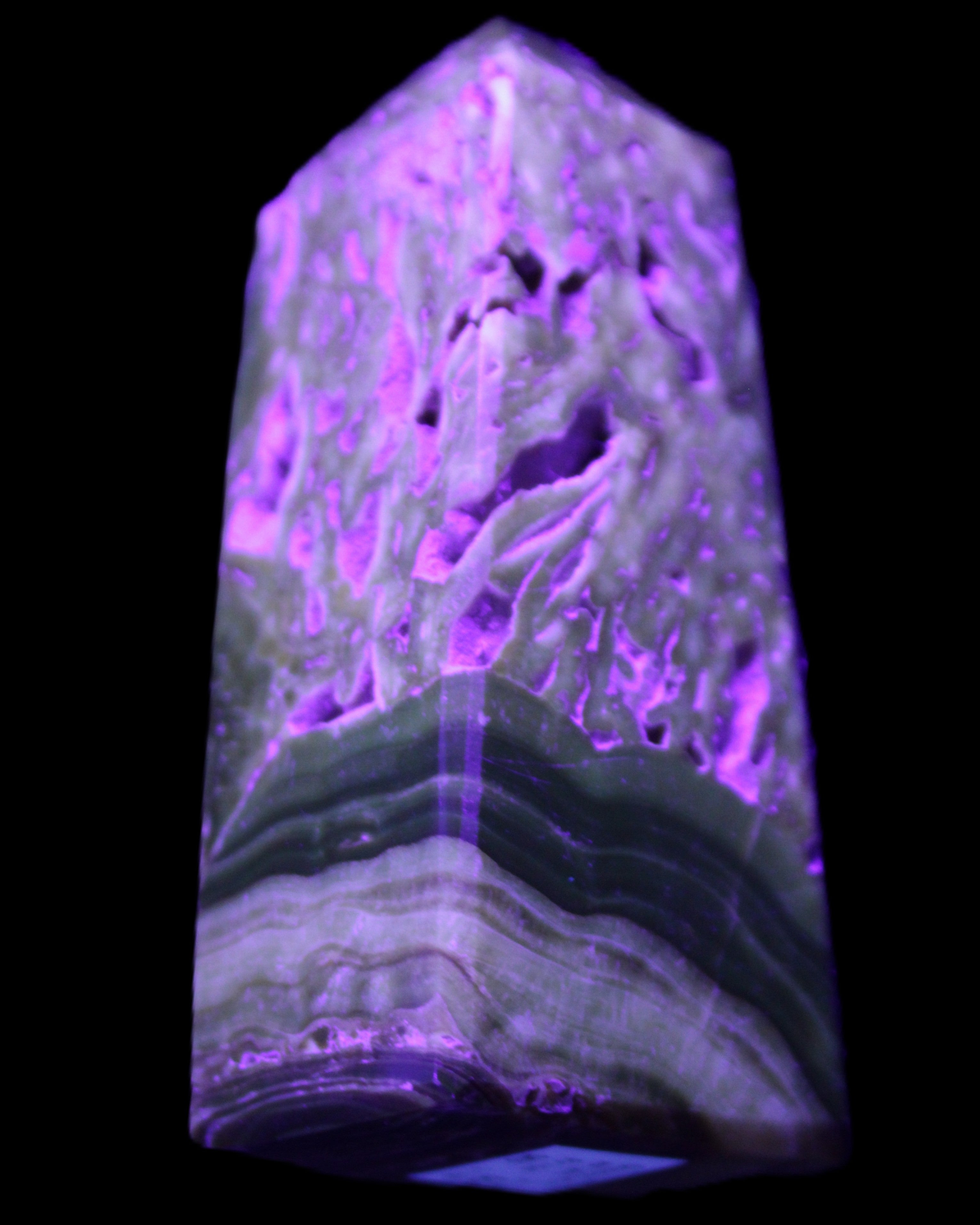 Chocolate Calcite obelisk with caves 95*40mm 217g in UV light - Rocks and Things Store
